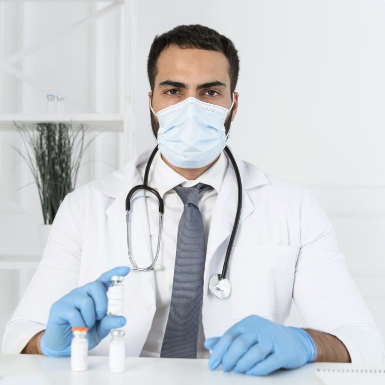doctor with medical mask holding vaccine recipient